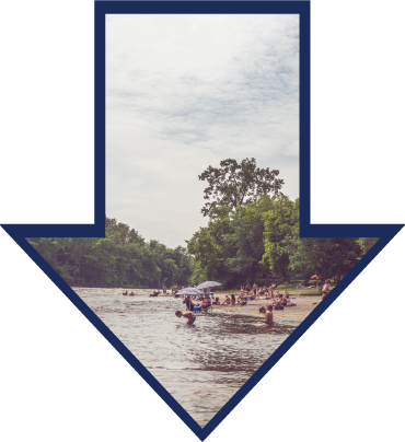 A DOWNWARD ARROW OF A SANDBAR WITH BEACHGOERS